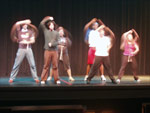 The 2005 Songfest hosts rehearse a number on stage while the tech crew makes the necessary adjustments to the lighting and sound