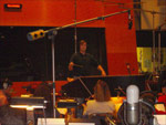 The recording light is on as Sam and the orchestra lay down a take