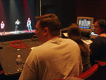 Sam looks on and directs from the lightboard as the Songfest technical rehearsal continues